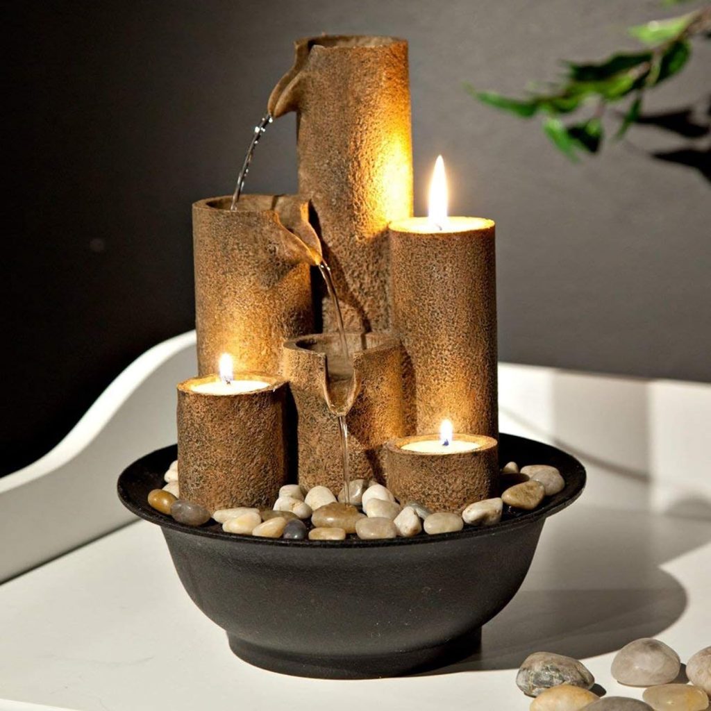 Introducing the Alpine Tiered Column Tabletop Fountain with 3 Candles, standing at 11 inches tall in a soothing brown hue. Crafted from durable cast stone resin, this fountain enhances your home, yard, and garden decor. The cascading stream and gentle water sounds create a Zen ambiance, while a 1-year warranty ensures worry-free operation. Elevate your space with tranquility.